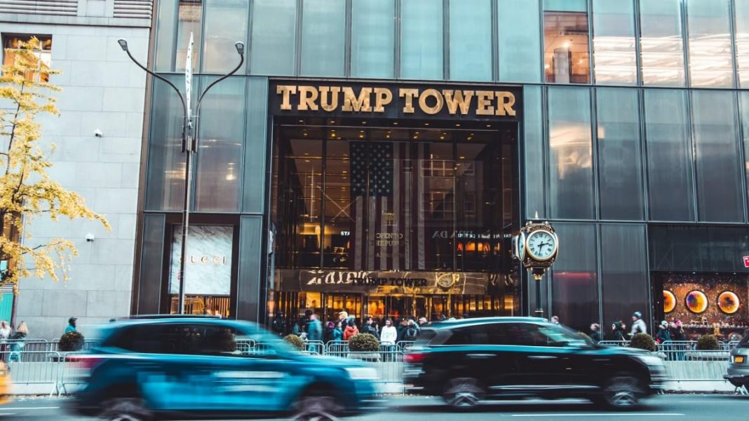 cars and people passing by trump tower