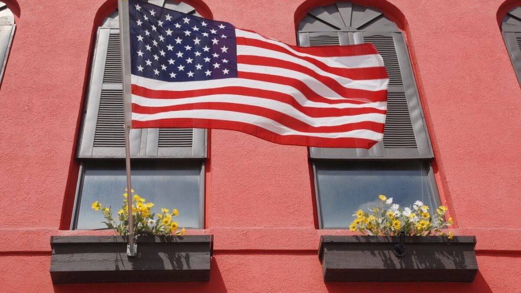 us flag with red wall on the background