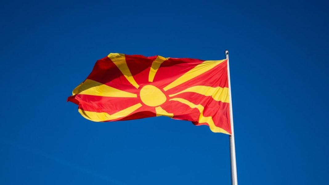 north macedonia flag waving in wind flagpole blue sky background
