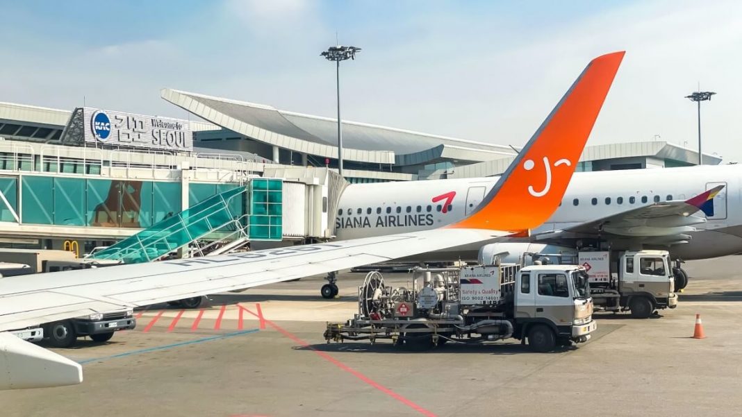airplane red white vertical stabilizer gmp airport south korea