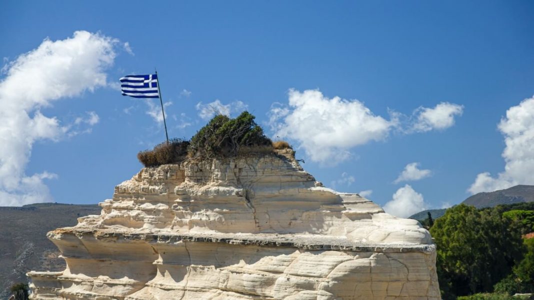 greek flag waving up in a rock