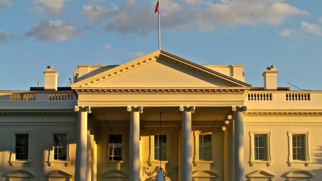 the white house with american flag sunrise view
