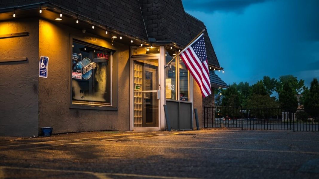 us flag hanging on roadside building