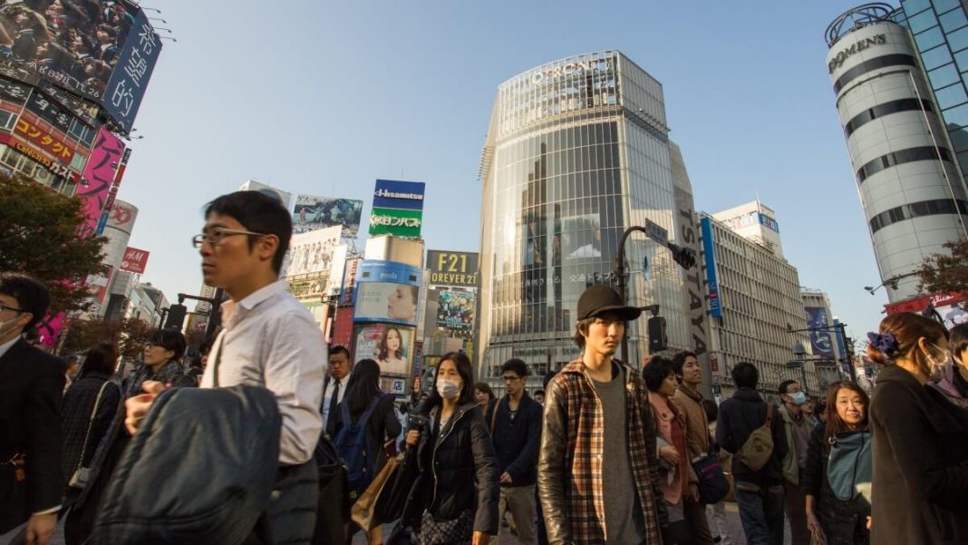 crowd of people tokyo buildings japan