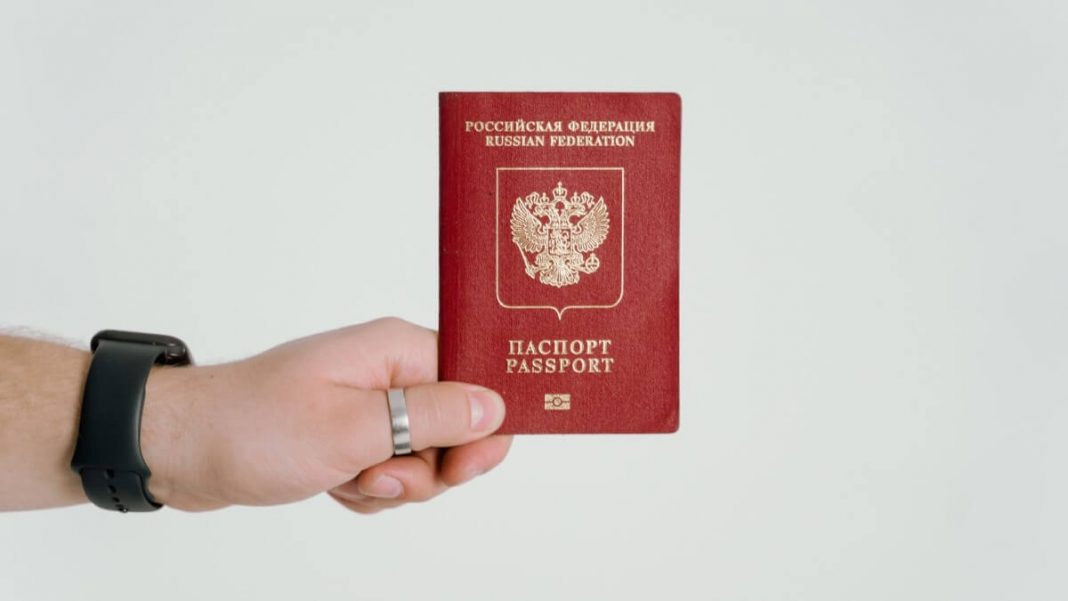person with russia passport on hand