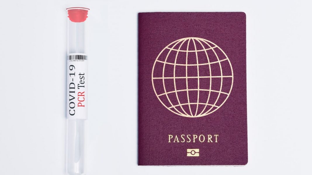 pcr test next to passport with globe icon