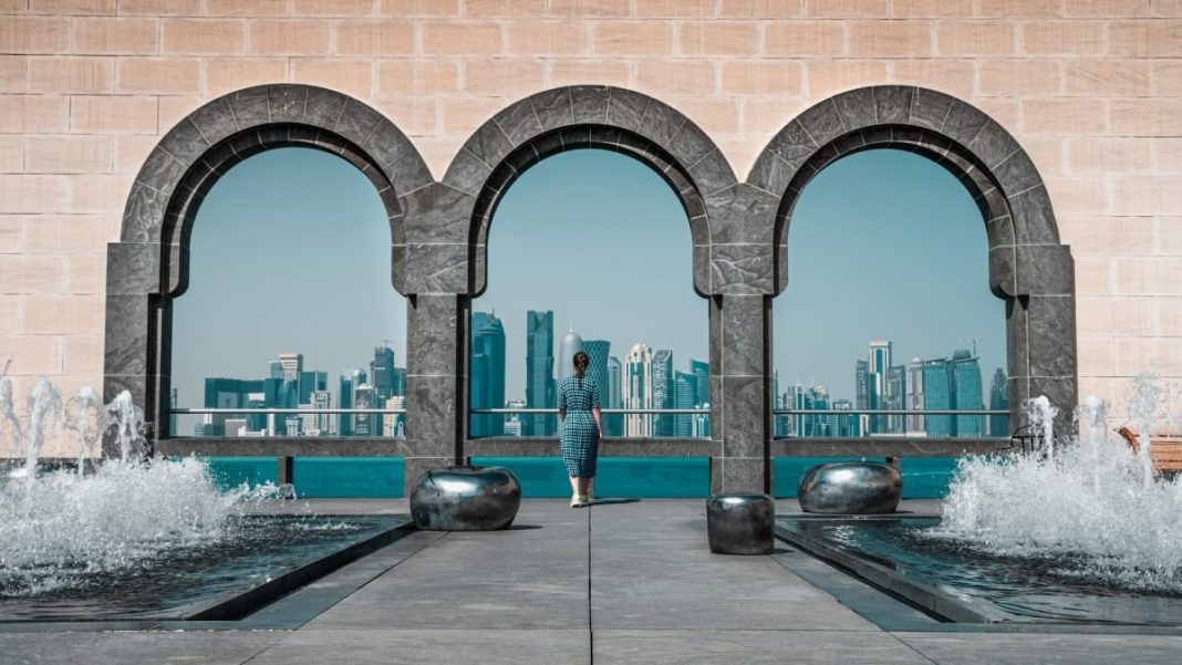 woman looking at doha buildings qatar