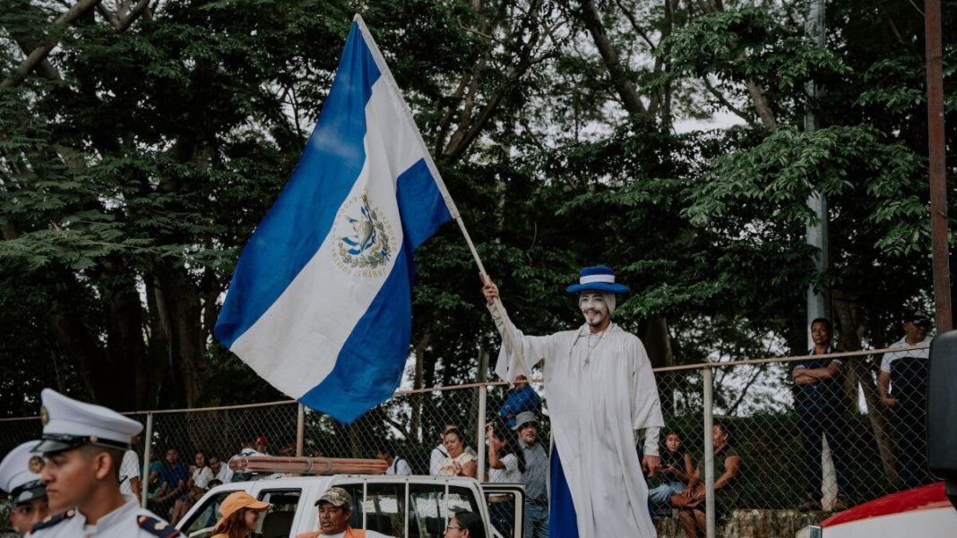 man dressed in white holding kazakhstan flag