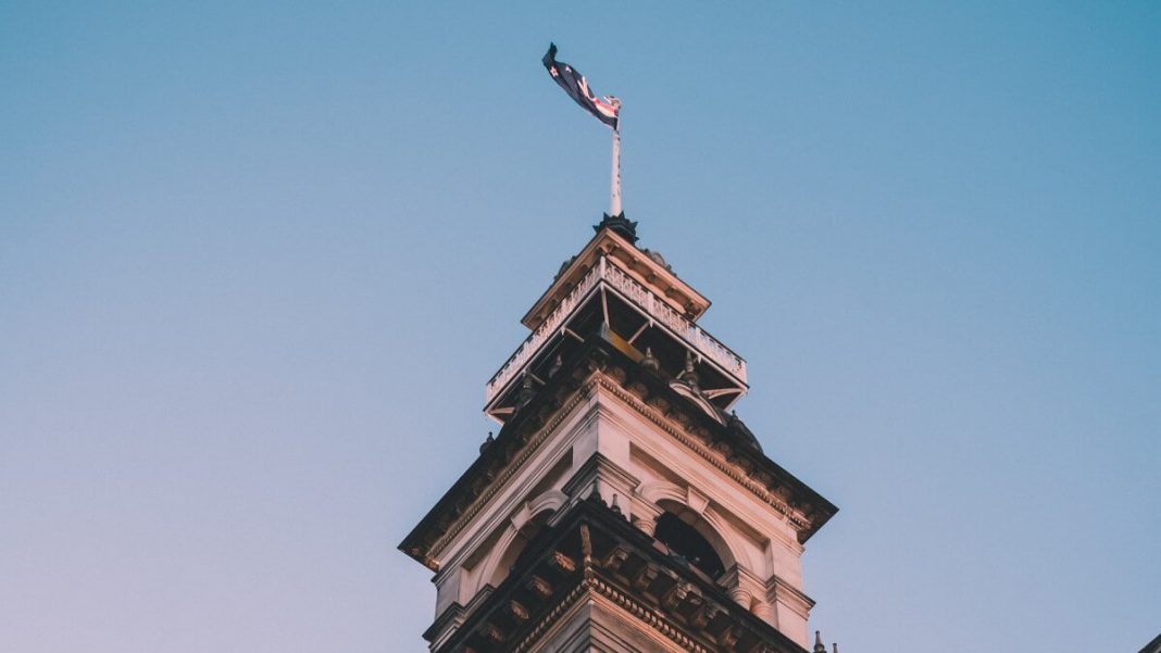new zealand flag waving up in dunedin building nz