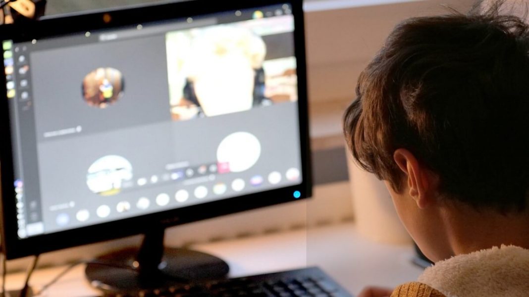 student having online lessons on computer