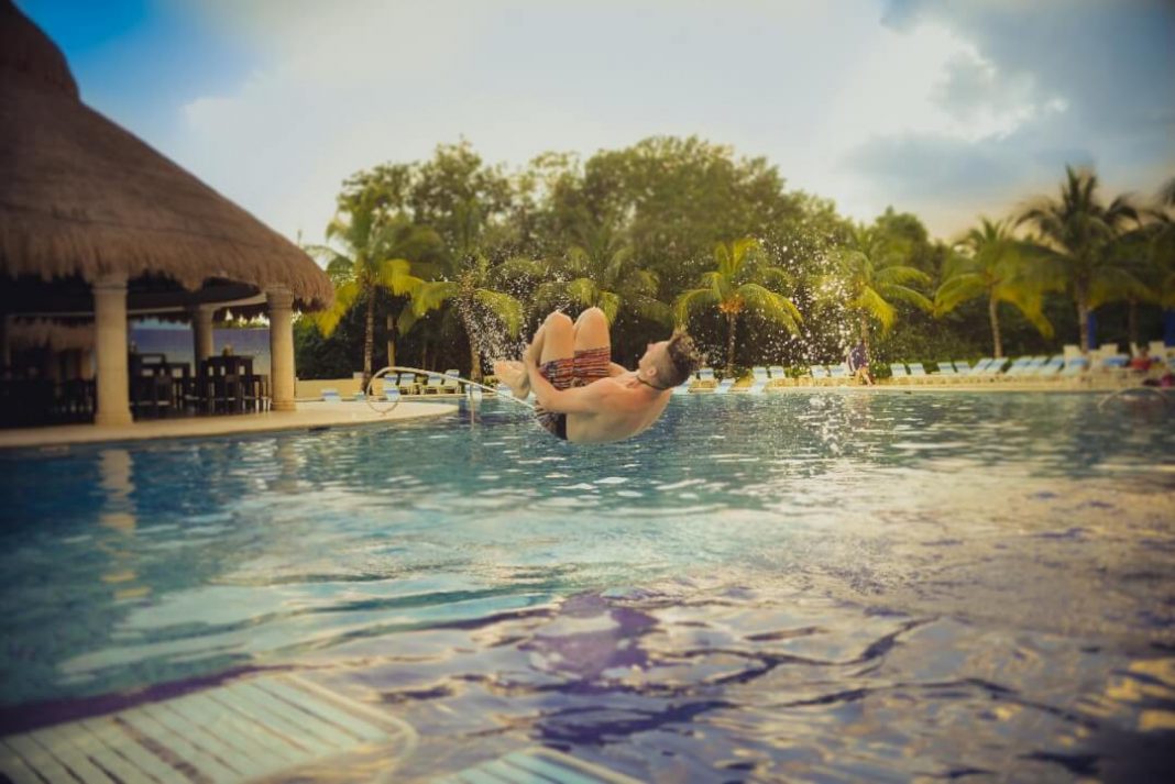 man jumping in pool