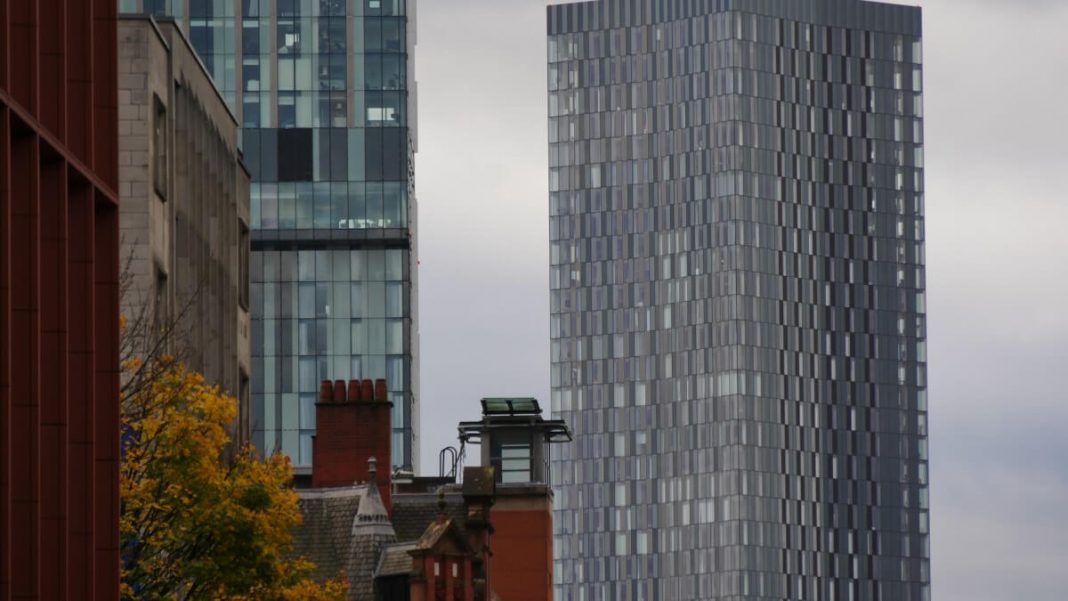 two gray towers next to each other manchester uk