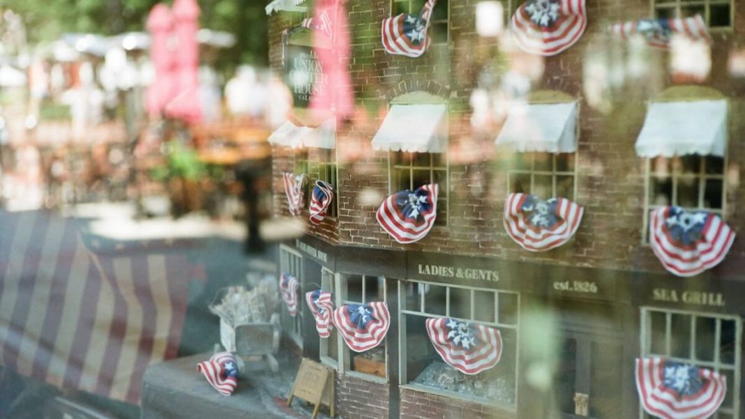brown building with us flags on the window