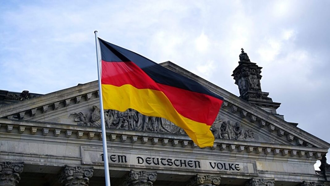 germany flag waving in front of building