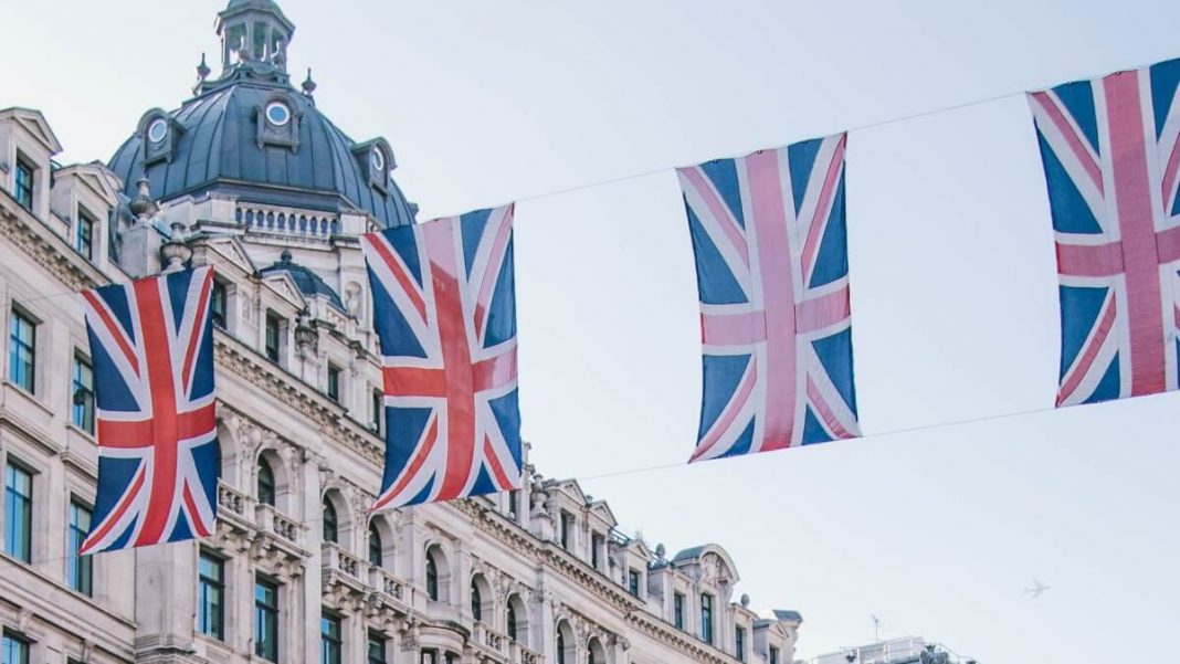uk flags hanging near white concrete building