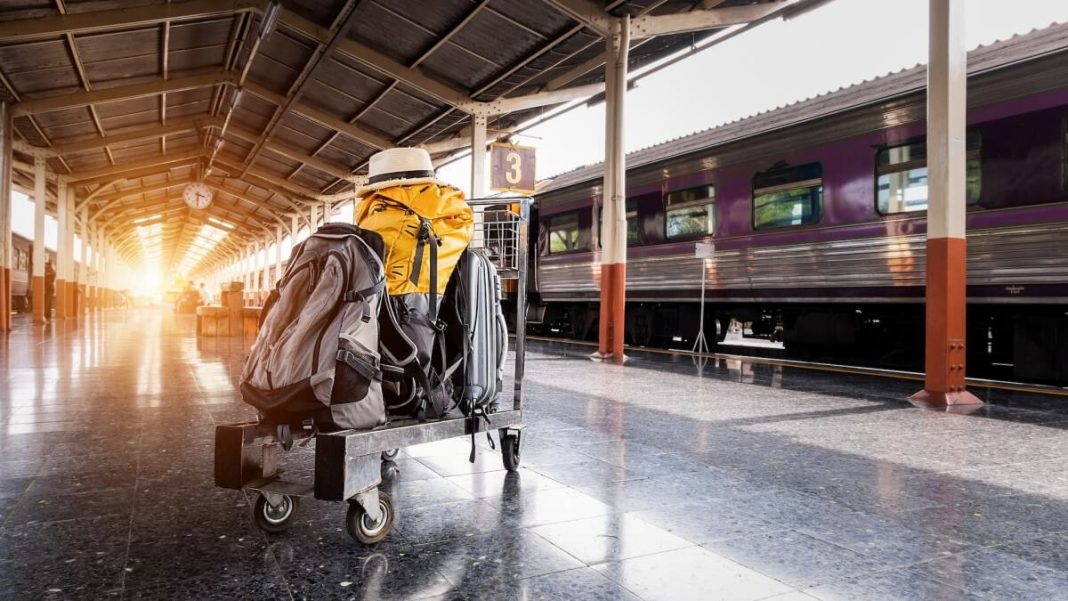 troller with black and yellow bags at the train station