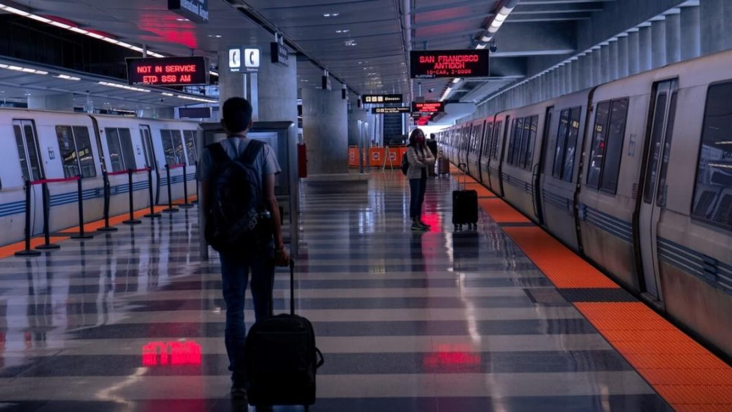 traveller holding luggage train station