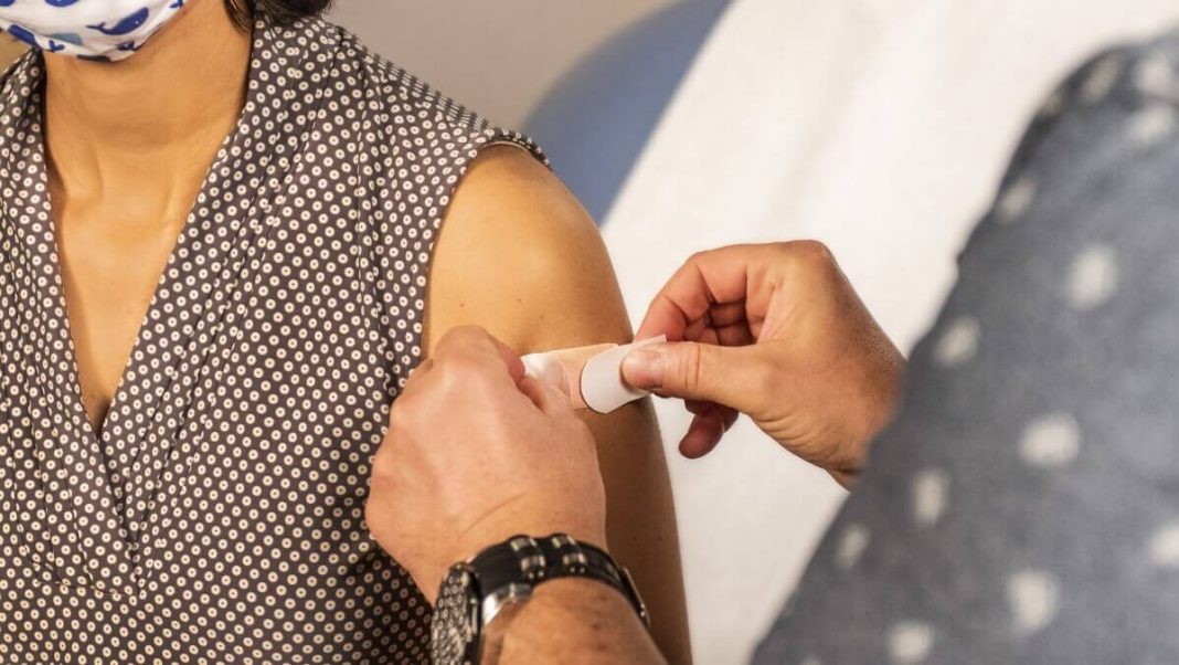 band aid on woman after vaccine