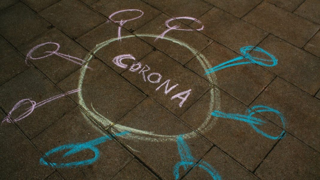 corona colorful chalk text on pavement