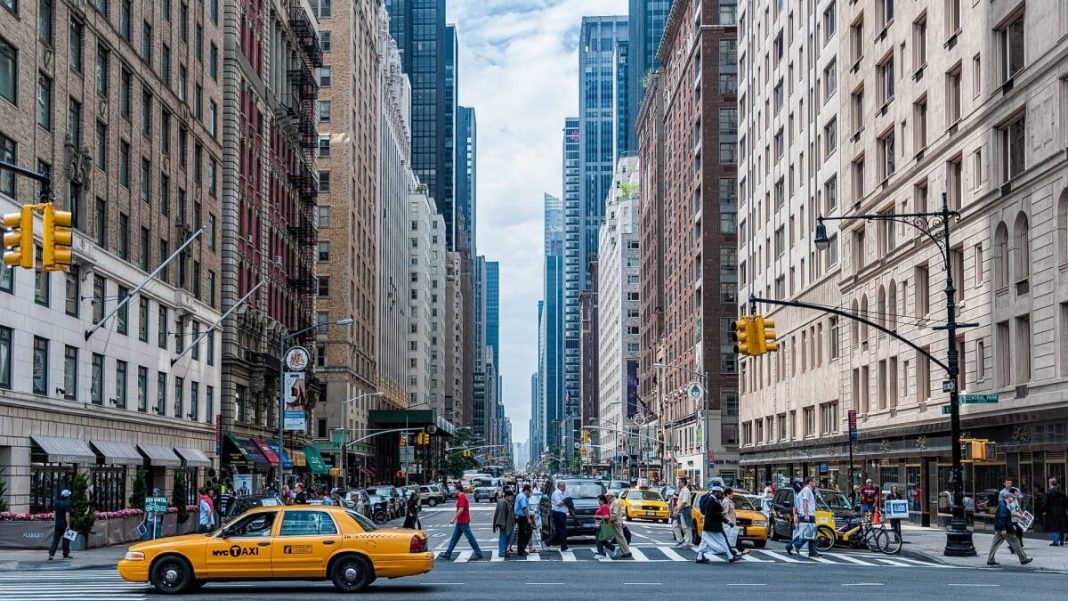 nyc traffic with people and yellow taxis