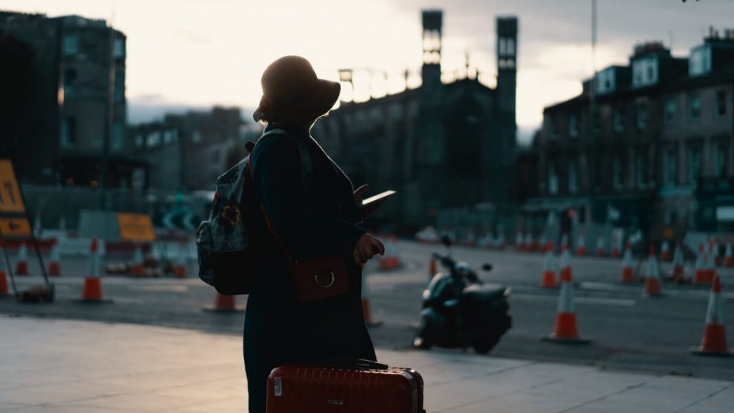 woman traveler with red luggage