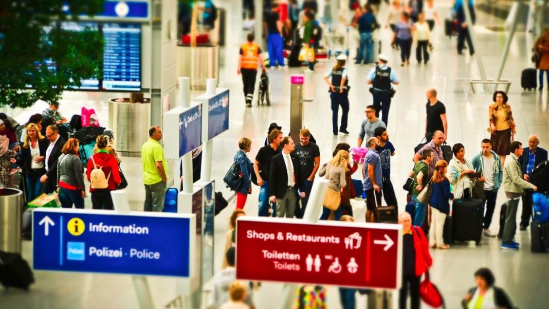 lines with travelers at the airport