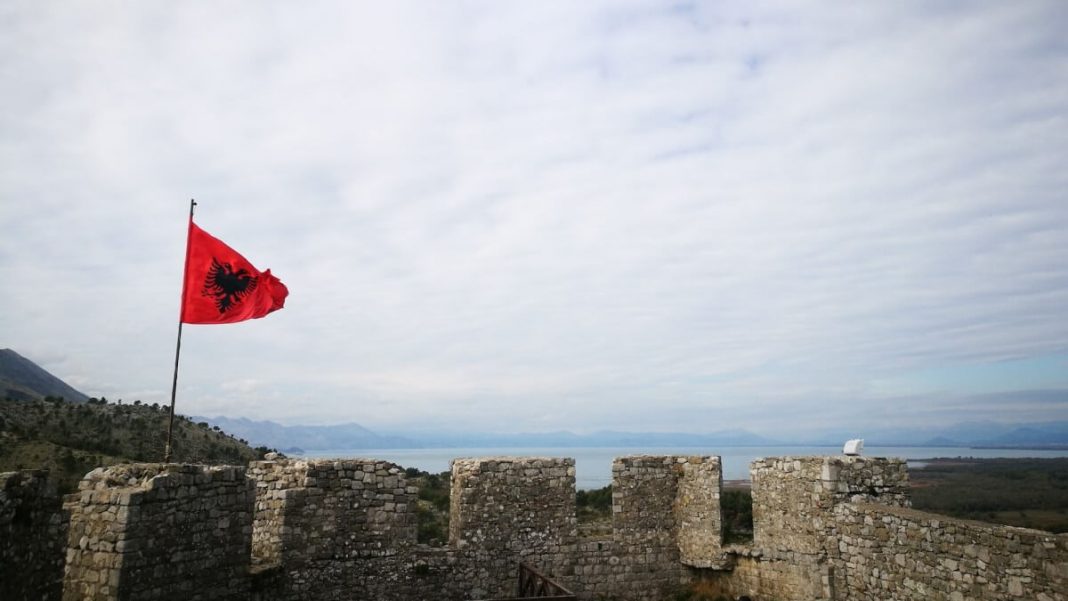 albanian flag hanging on castle