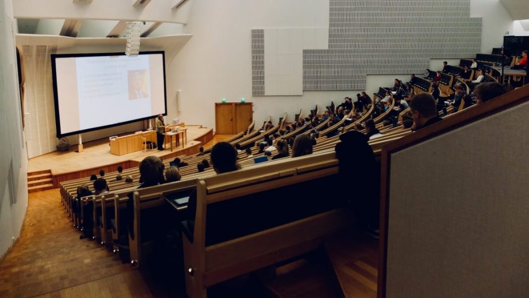 students in college sitting in front of presentation