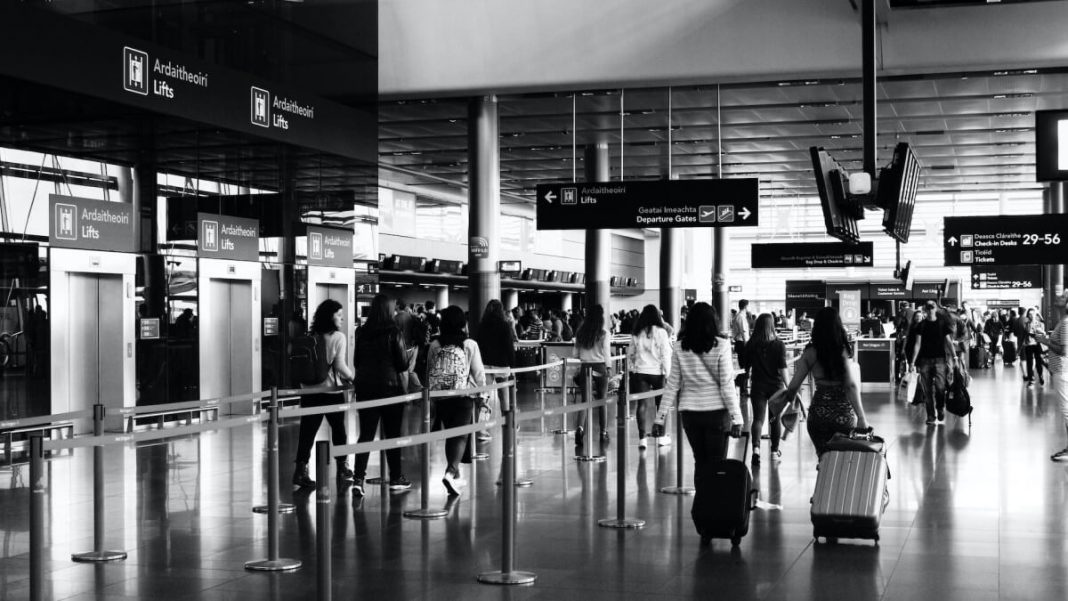 black and white people with luggages at the airport