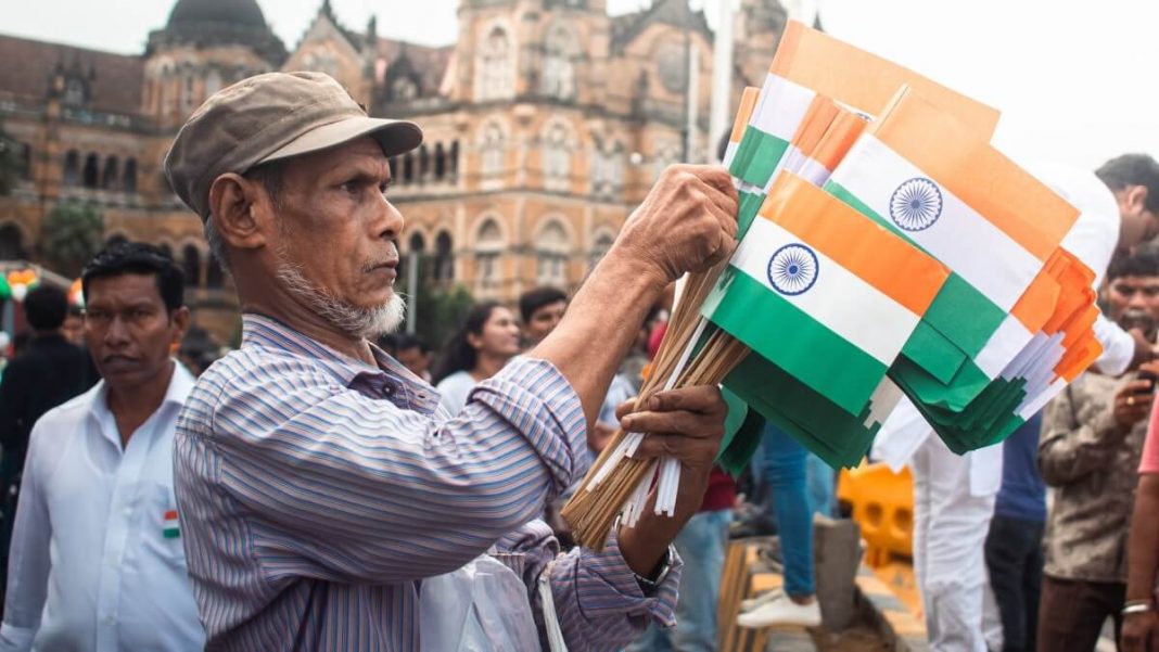old man selling india flags