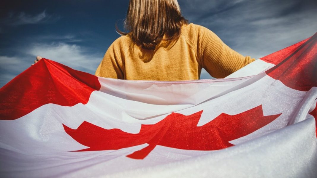 girl with canada flag on her back