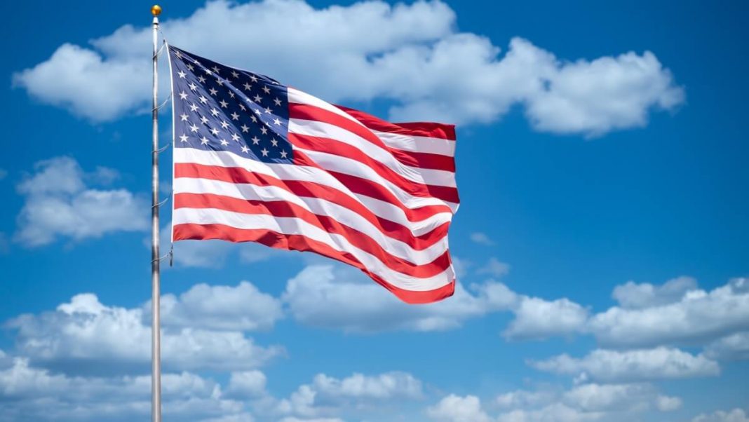 us flag waving blue sky clouds background