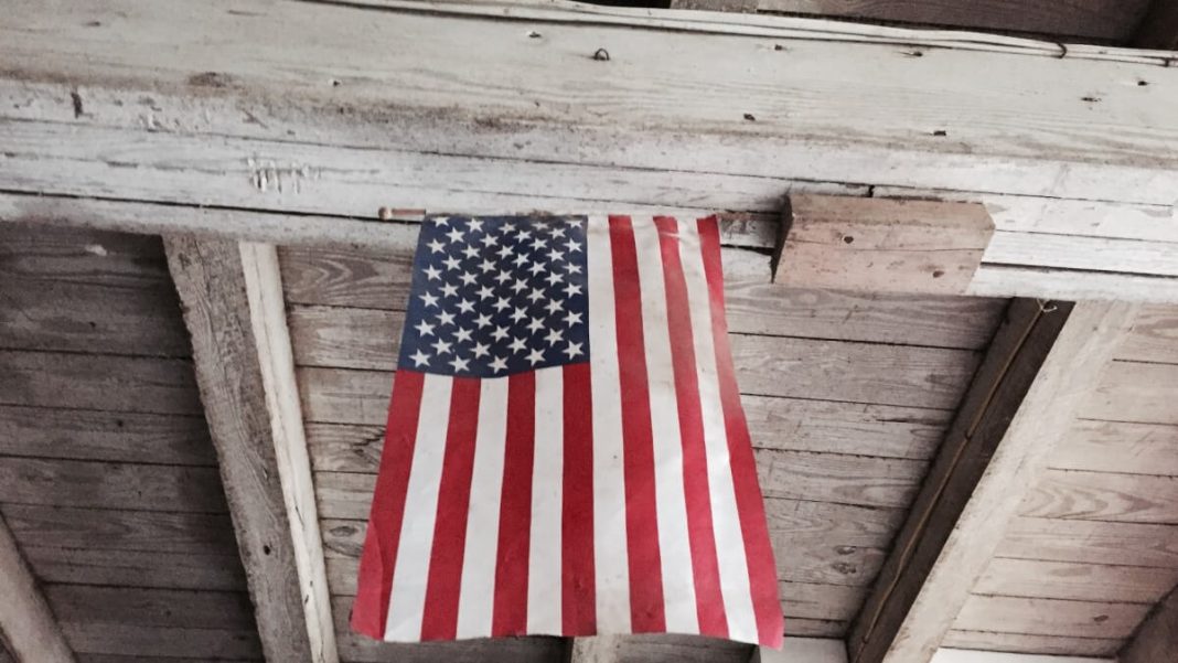 us flag hanging on wooden ceiling