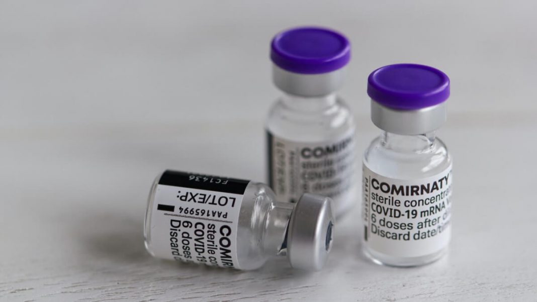 covid-19 small transparent and blue vaccination bottles