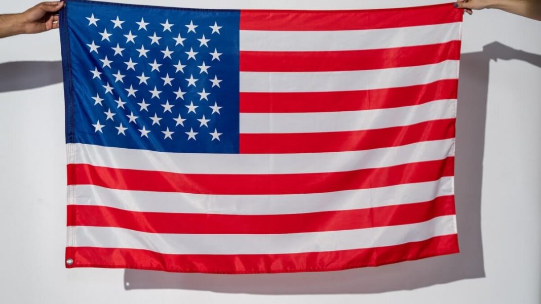 people holding us flag