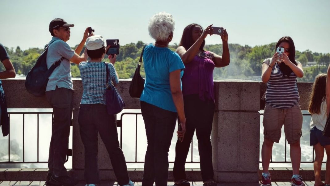 tourists taking pictures of tourist attractions