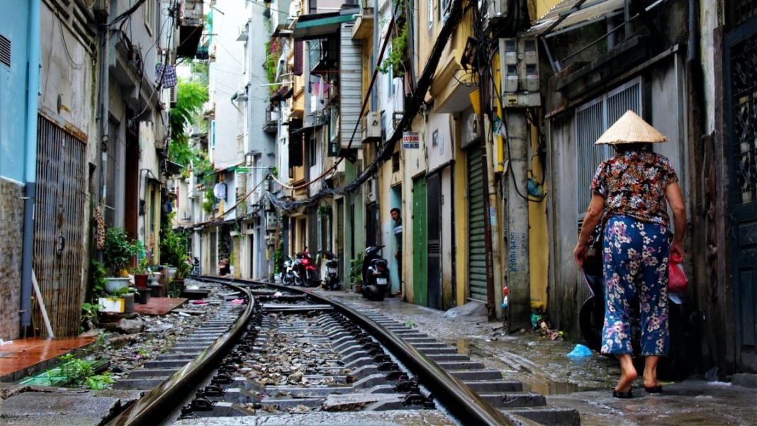 woman wearing non la train railway in hanoi city vietnam