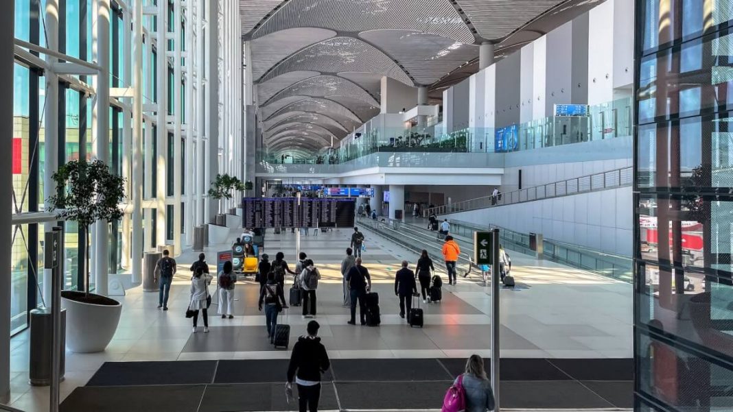 travelers walking with luggages at the airport