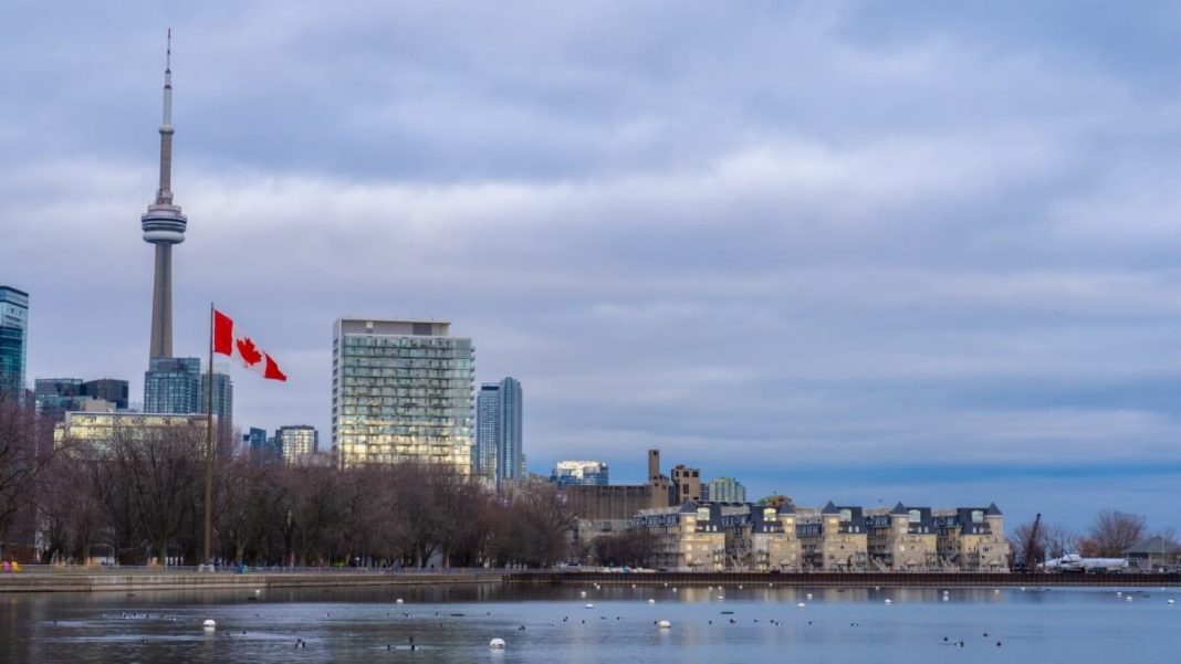 canada flag waving flagpole toronto city view