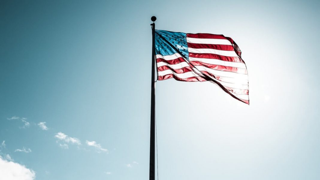 us flag in front of sunlight