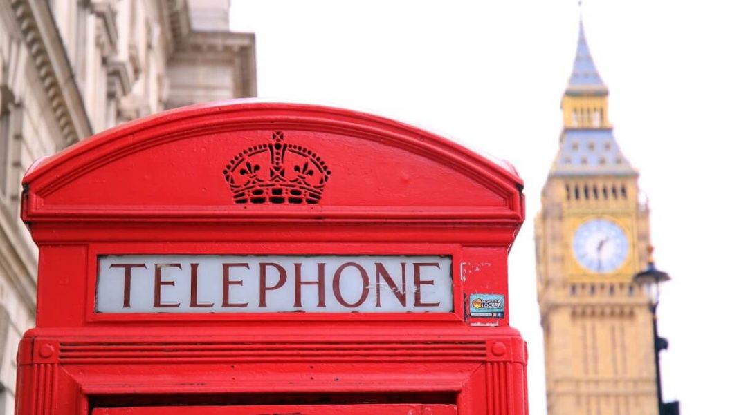 red telephone booth with big ben on the background london