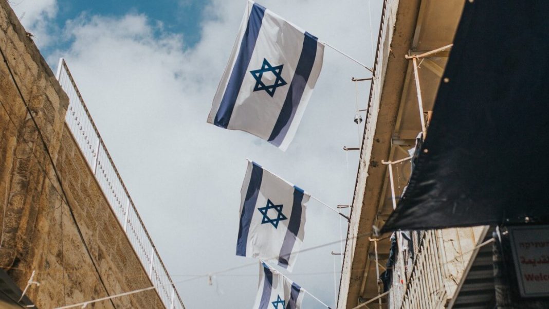 israel flags hanging on roofs daytime