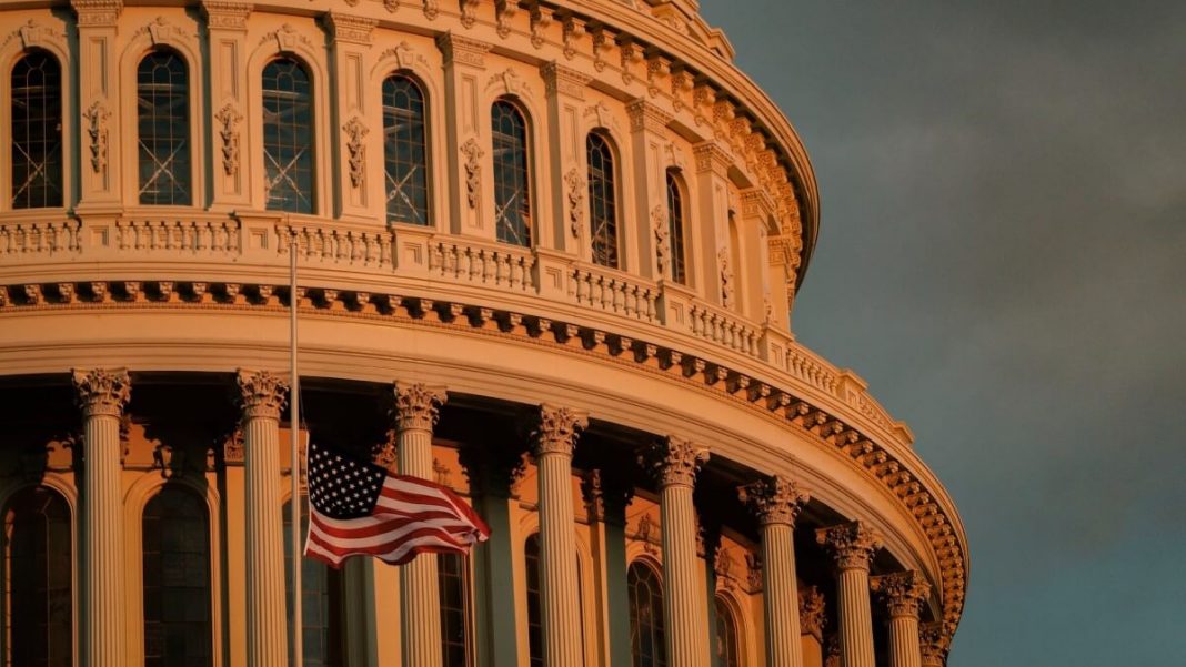 usa flag waving in front of white building during golden hour