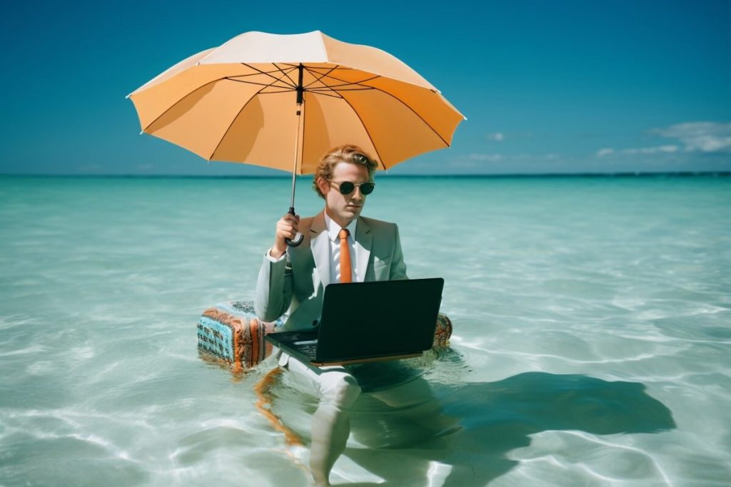 digital nomad working in the beach covered from the sun
